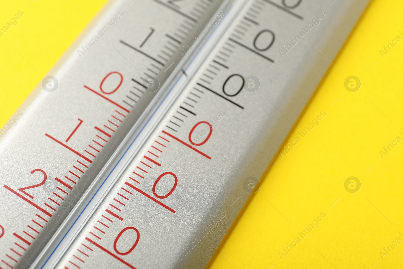 Photo of Modern weather thermometer on yellow background, closeup