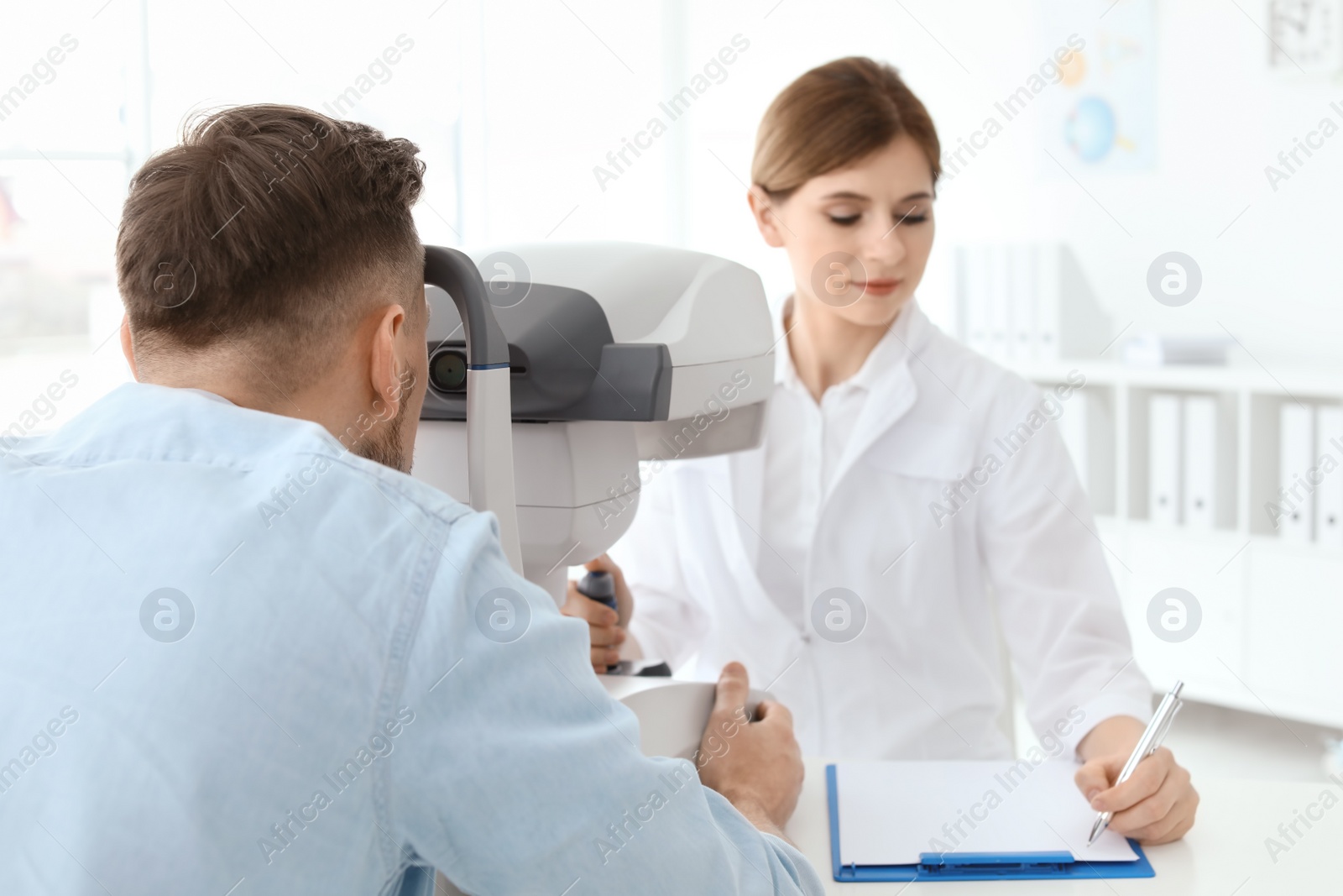 Photo of Ophthalmologist examining patient in clinic