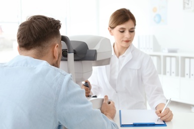 Ophthalmologist examining patient in clinic