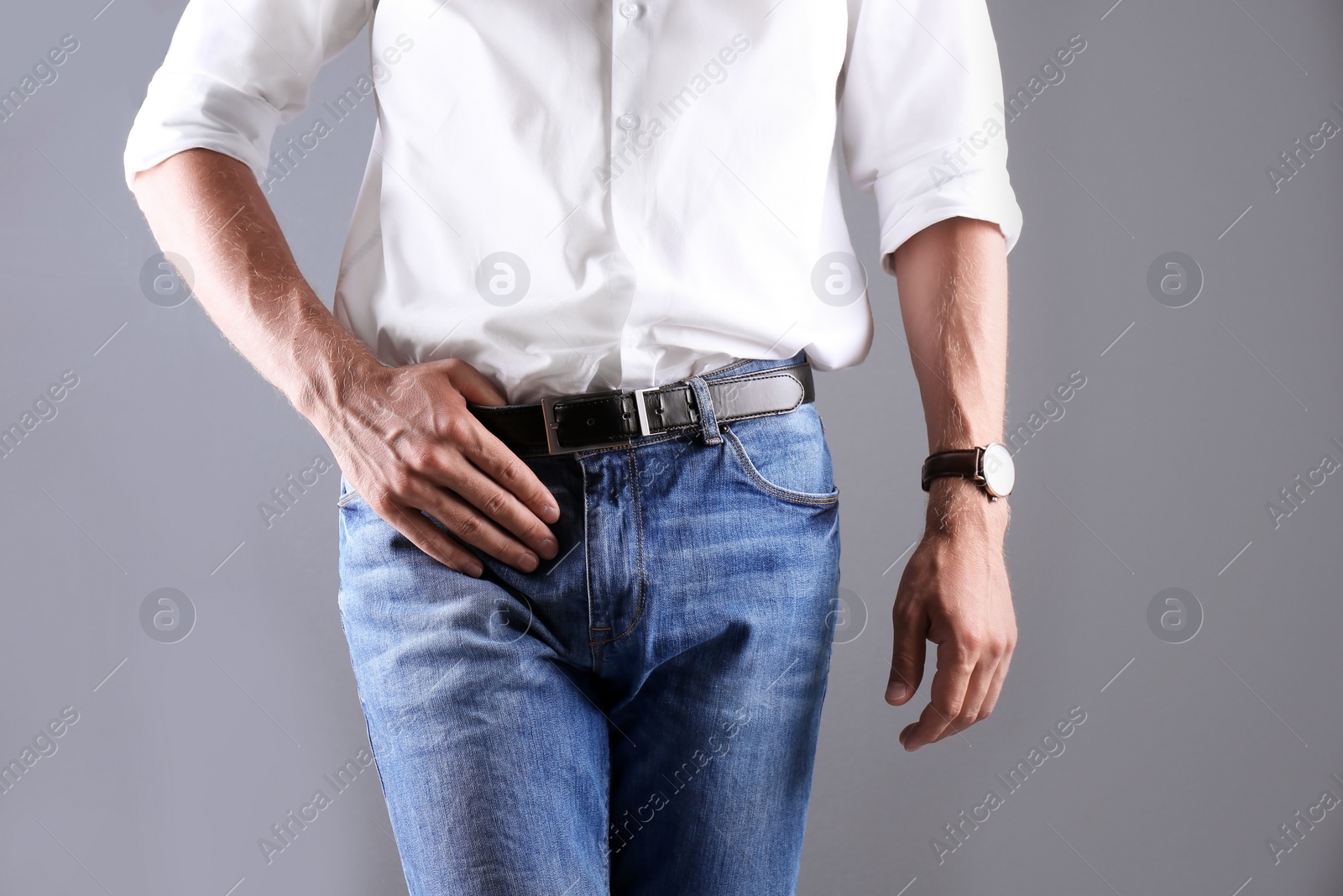 Photo of Man in stylish blue jeans on grey background