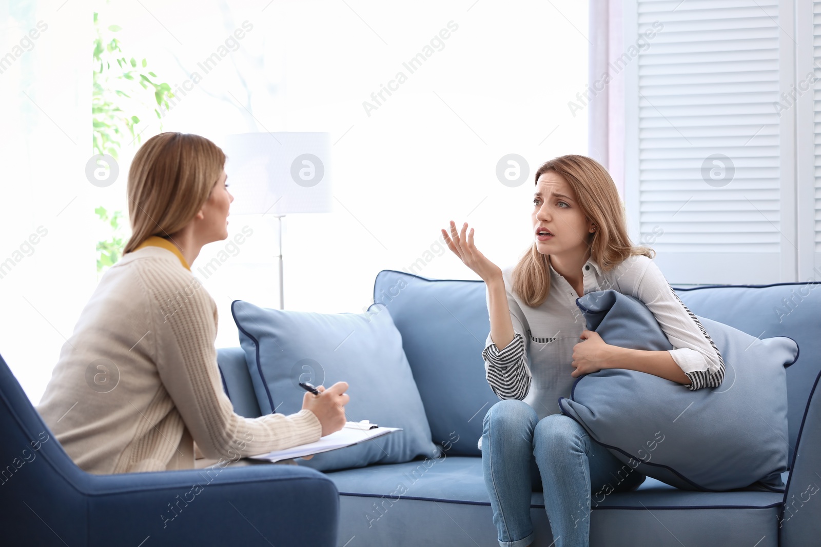 Photo of Female psychologist with client in office