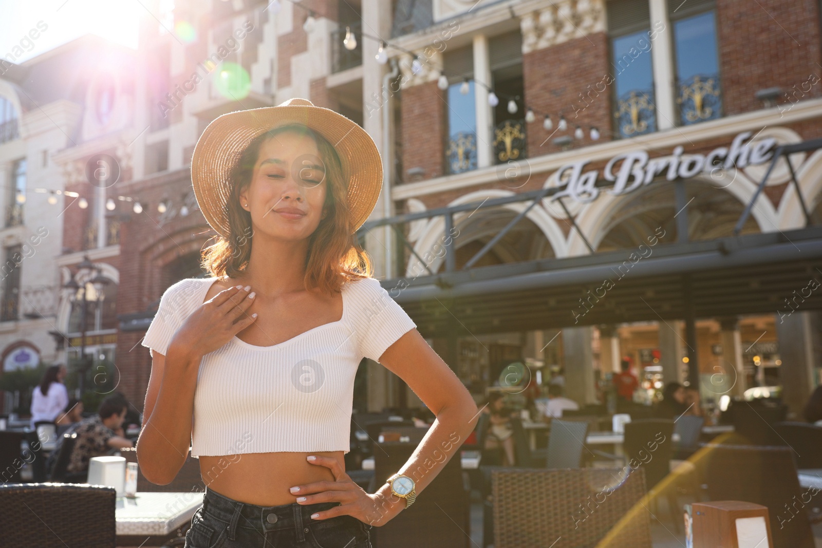 Photo of Portrait of happy young woman on city street. Space for text