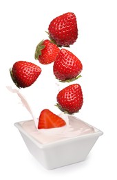 Image of Delicious ripe strawberries falling into bowl with yogurt on white background