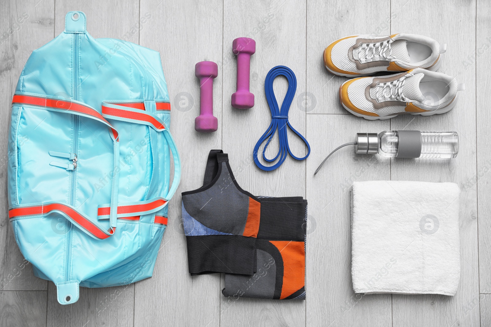 Photo of Flat lay composition with sports bag on wooden background