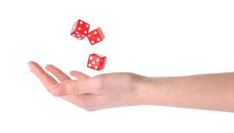 Photo of Woman throwing game dices on white background, closeup