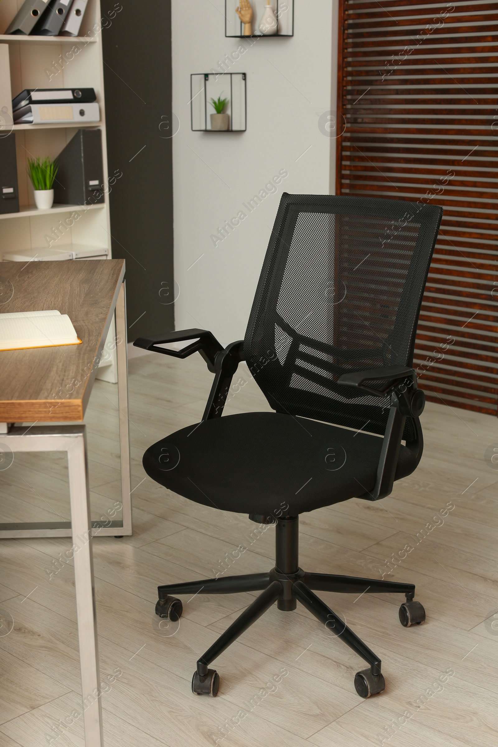 Photo of Stylish office chair at workplace in room. Interior design