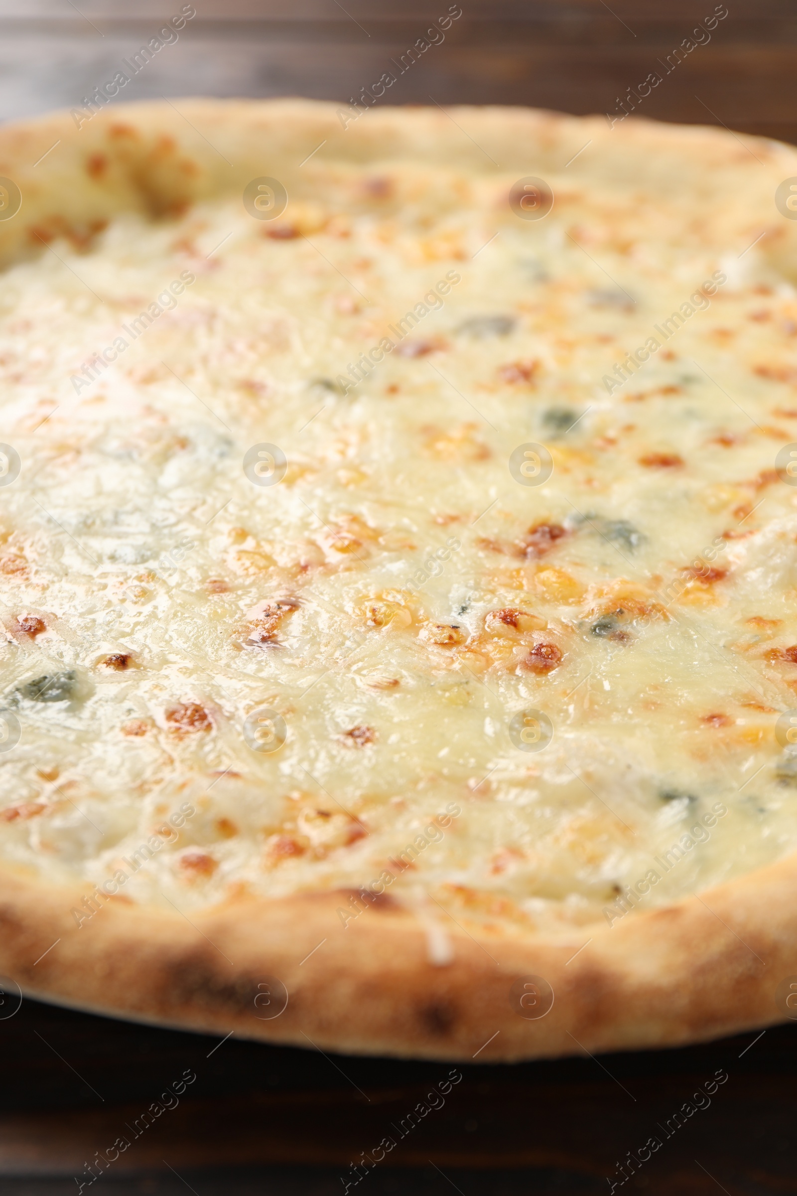 Photo of Delicious cheese pizza on wooden table, closeup