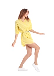 Photo of Beautiful young woman in yellow dress dancing on white background