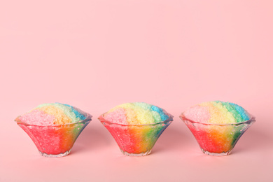 Photo of Rainbow shaving ice in glass dessert bowls on pink background