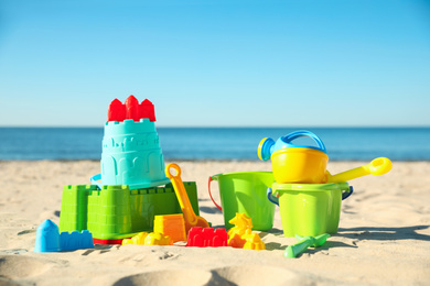 Different child plastic toys on sandy beach