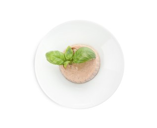 Photo of Plate of delicious meat pate with basil leaves isolated on white, top view
