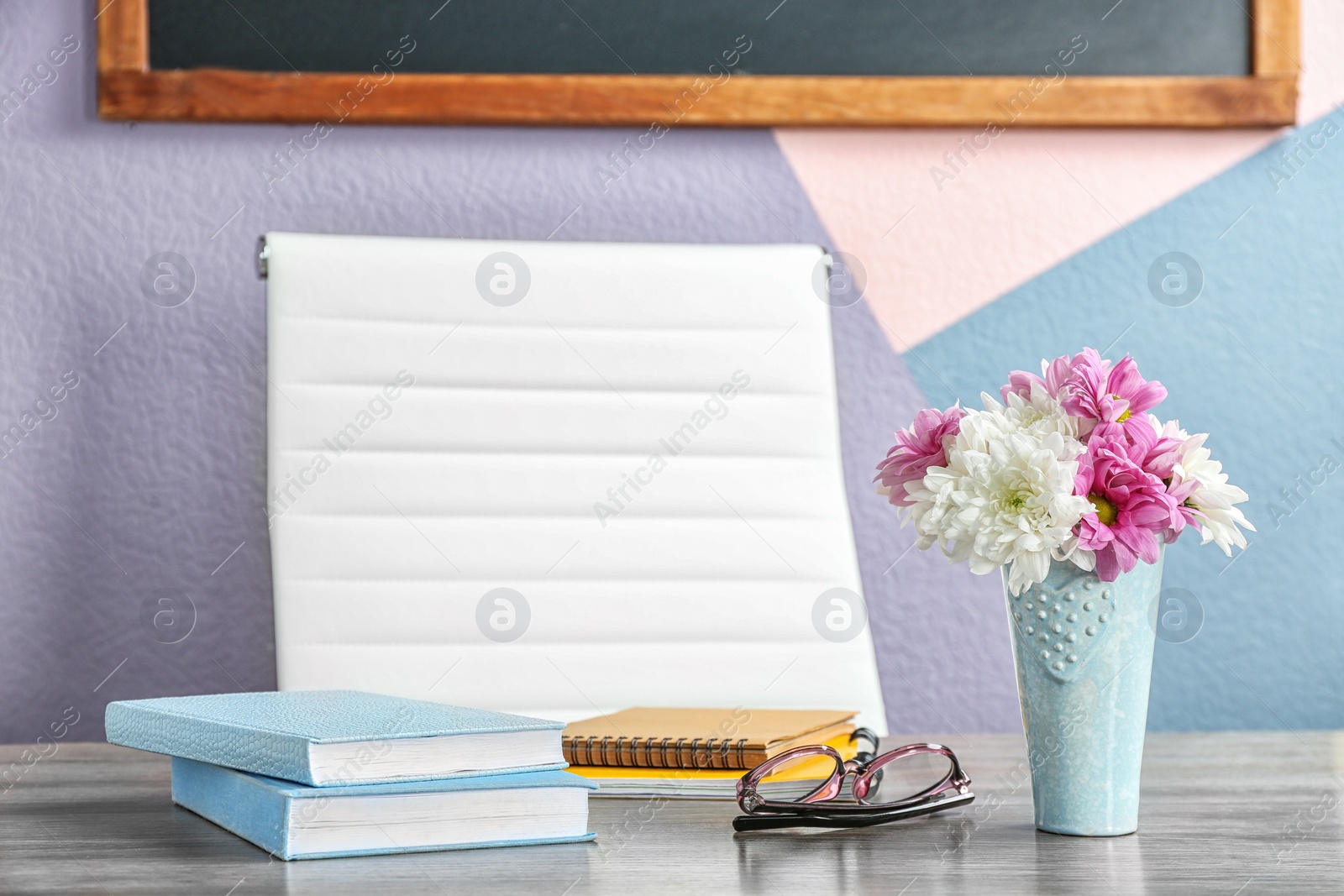 Photo of Beautiful bouquet on table in classroom. Teacher's day celebration