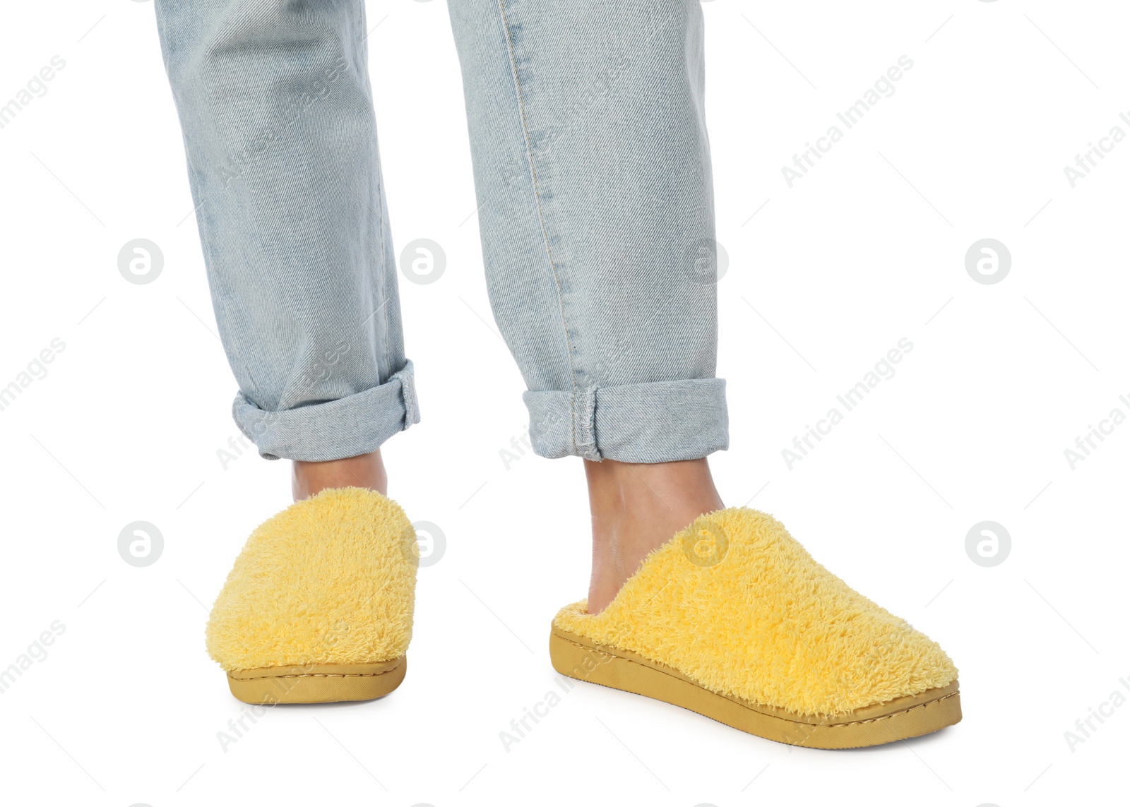 Photo of Woman in yellow soft slippers on white background, closeup