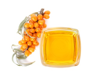 Natural sea buckthorn oil and fresh berries on white background, top view