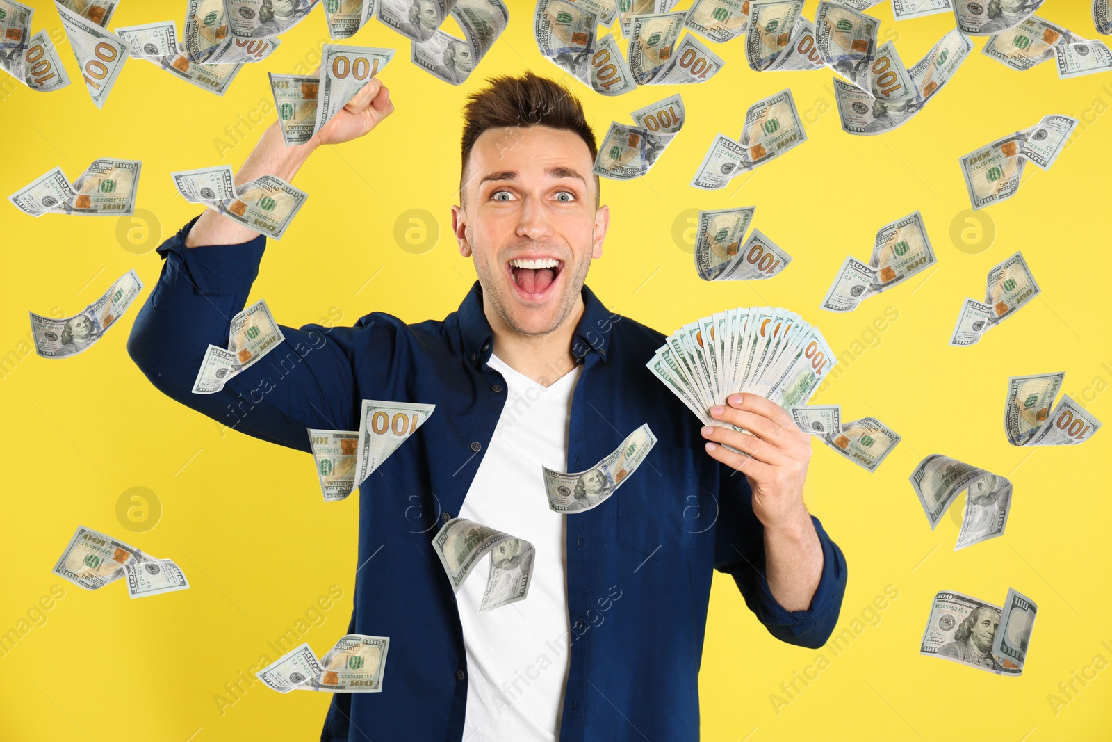 Image of Man with American dollars under money rain on yellow background