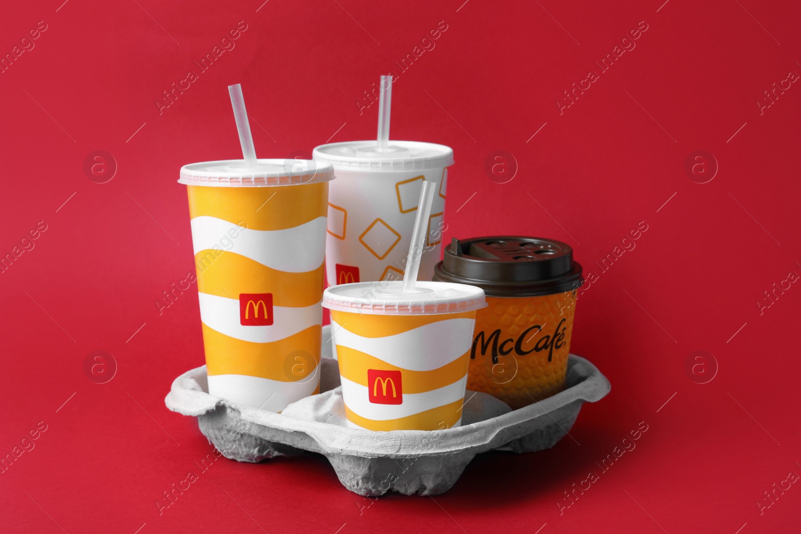 Photo of MYKOLAIV, UKRAINE - AUGUST 12, 2021: Cold and hot McDonald's drinks on red background