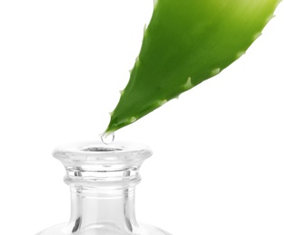 Photo of Aloe juice dripping from leaf into bottle on white background