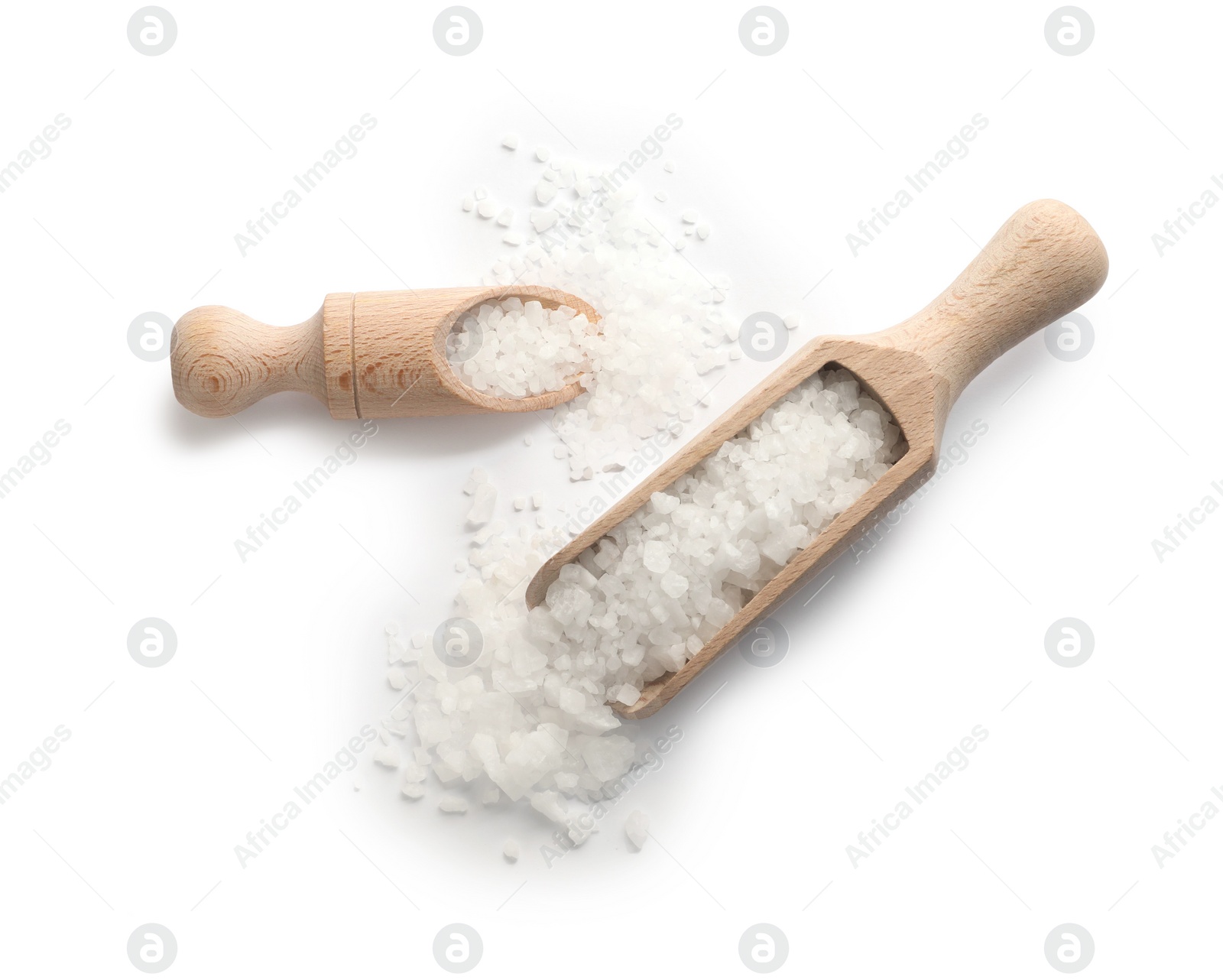 Photo of Natural salt and wooden scoops isolated on white, top view