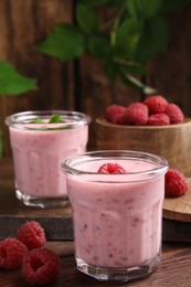 Photo of Tasty fresh raspberry smoothie on wooden table