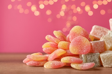 Pile of tasty sweets on wooden table, closeup. Space for text