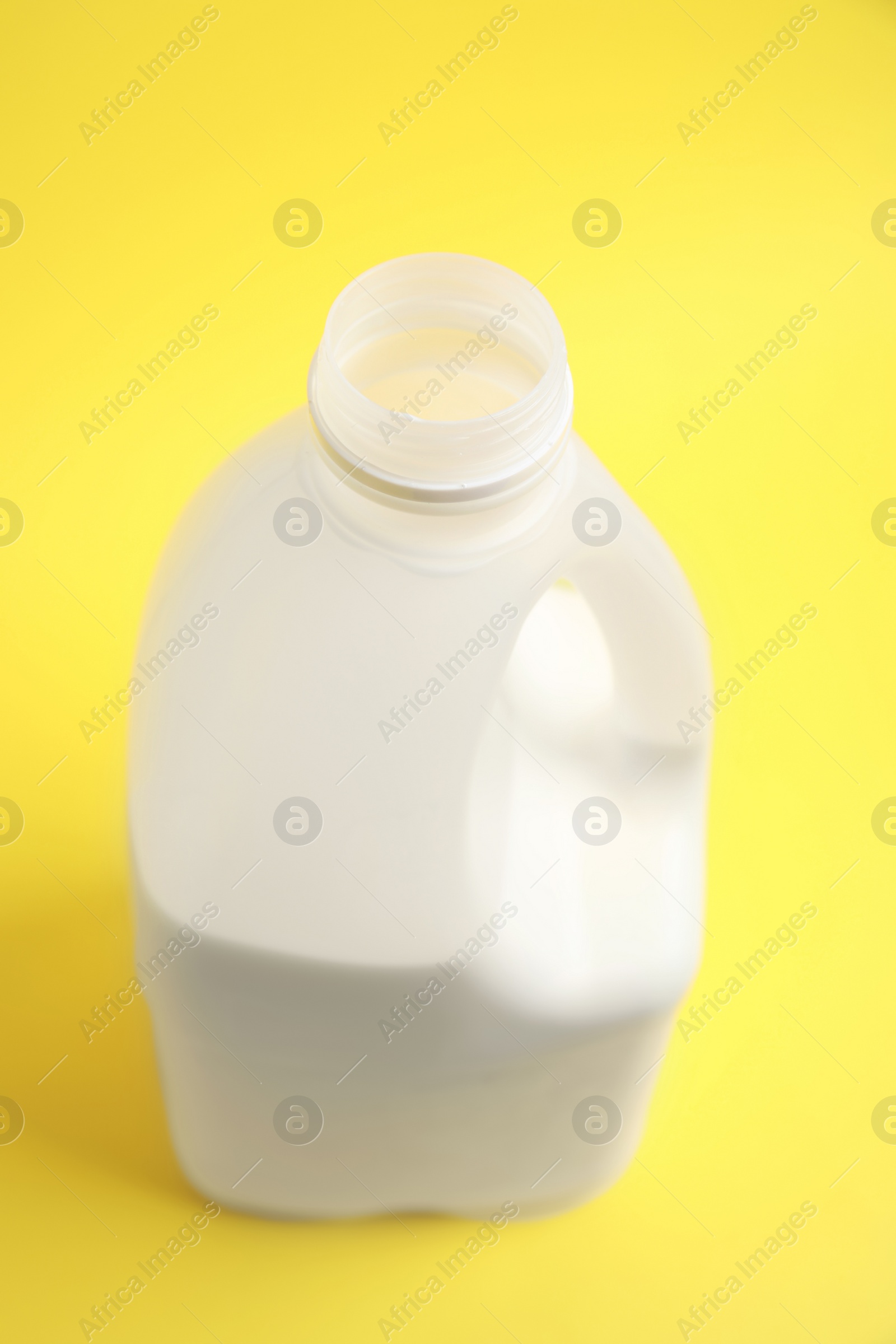 Photo of Gallon bottle of milk on yellow background