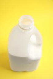 Photo of Gallon bottle of milk on yellow background