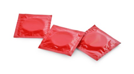 Photo of Condom packages isolated on white. Safe sex