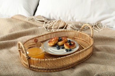 Delicious cottage cheese pancakes with fresh blueberries and sour cream served on bed tray