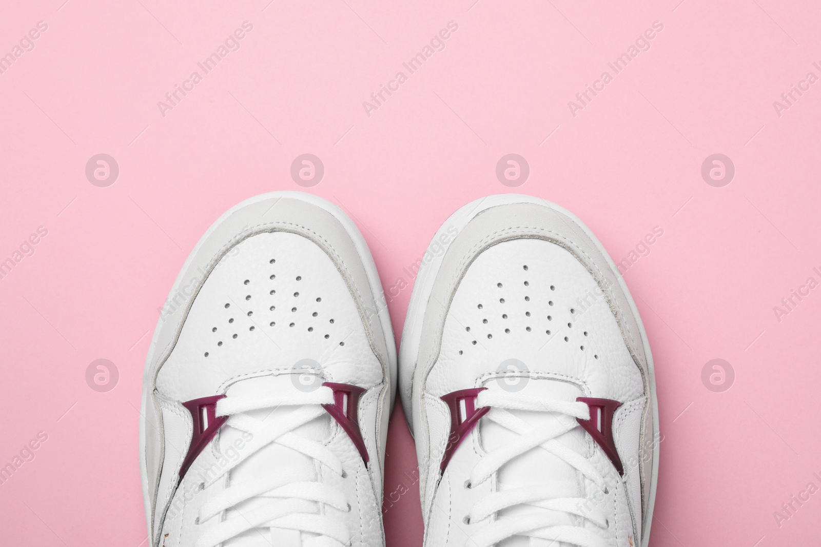 Photo of Pair of stylish shoes on pink background, top view. Space for text