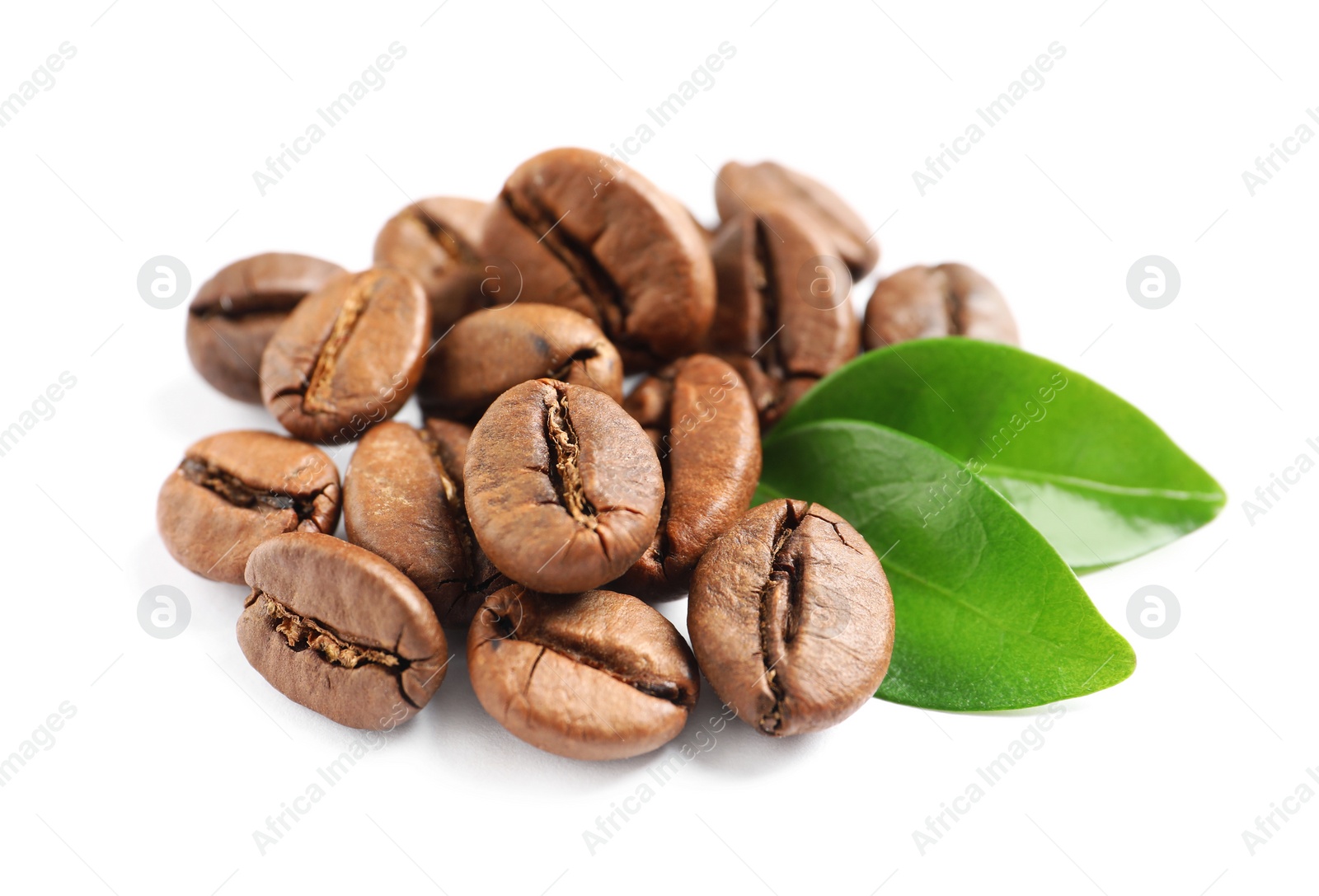 Photo of Roasted coffee beans and fresh green leaves on white background