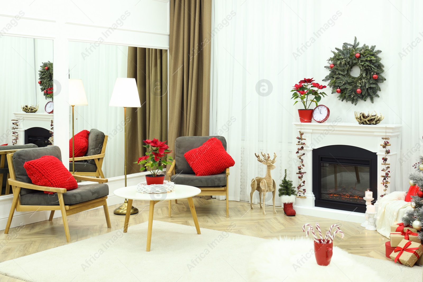 Photo of Beautiful living room interior with burning fireplace and Christmas decor