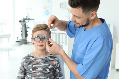 Ophthalmologist examining little boy in clinic