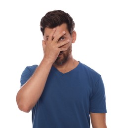 Photo of Embarrassed man covering face with hand on white background