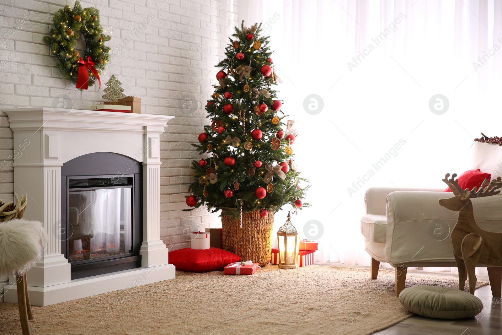 Photo of Beautiful decorated Christmas tree in festive room interior