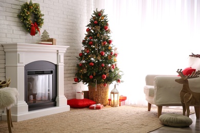 Photo of Beautiful decorated Christmas tree in festive room interior