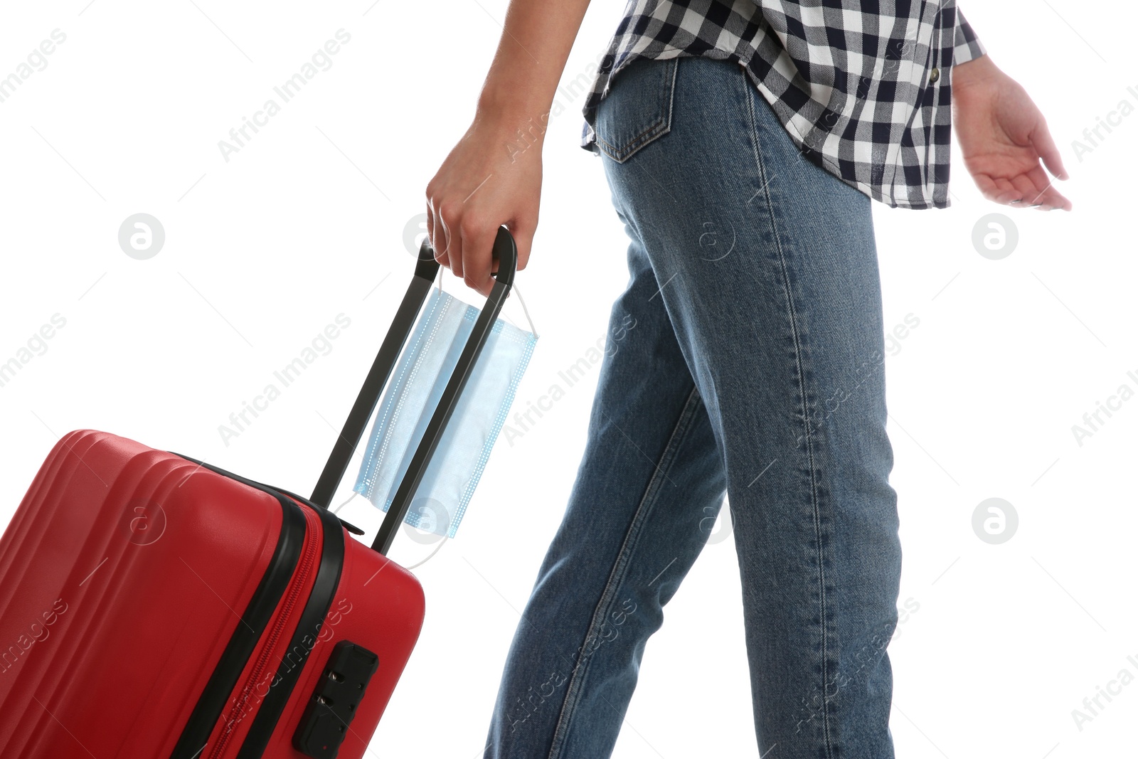 Photo of Woman with suitcase and protective mask on white background, closeup. Travelling during coronavirus pandemic