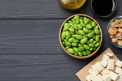 Different organic soy products on grey wooden table, flat lay. Space for text