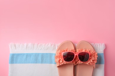 Flat lay composition with beach accessories on pink background, space for text