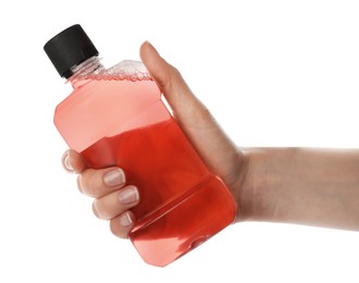 Woman holding bottle with mouthwash for teeth care on white background, closeup