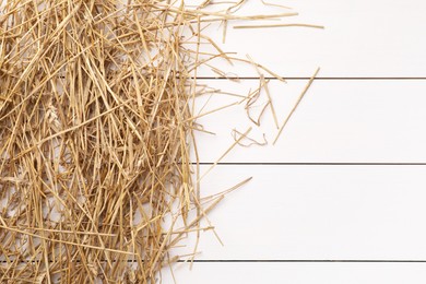 Photo of Dried straw on white wooden table, top view. Space for text
