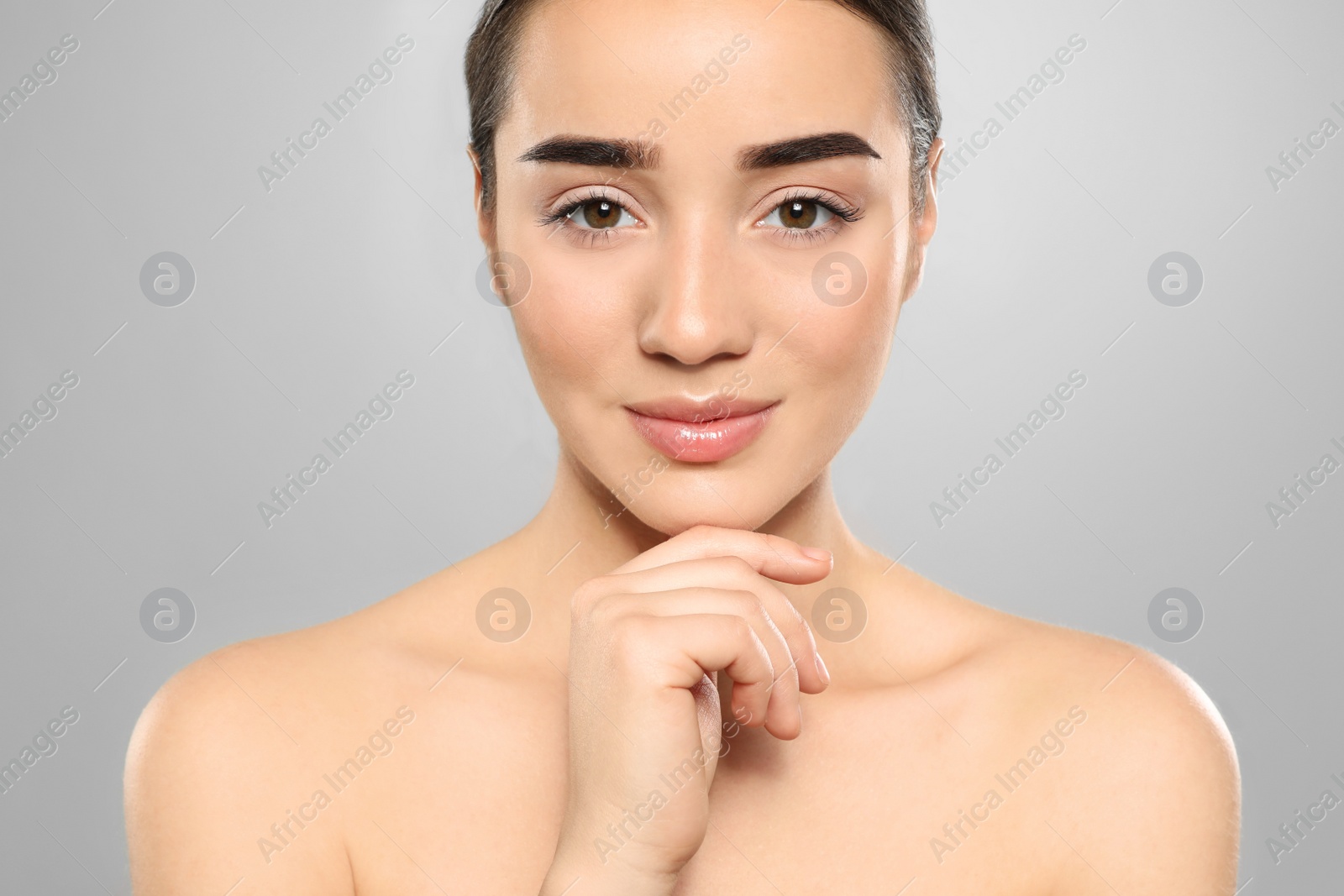 Photo of Portrait of young woman with beautiful face against color background