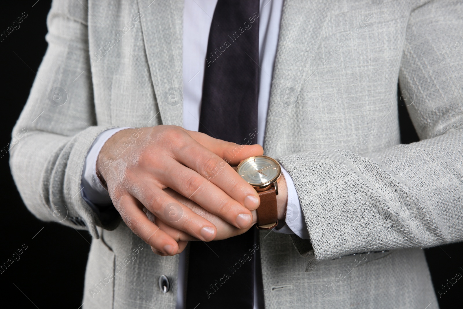 Photo of Businessman wearing wristwatch, closeup view. Time management