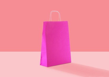 Image of Pink paper bag on color background. Mockup for design