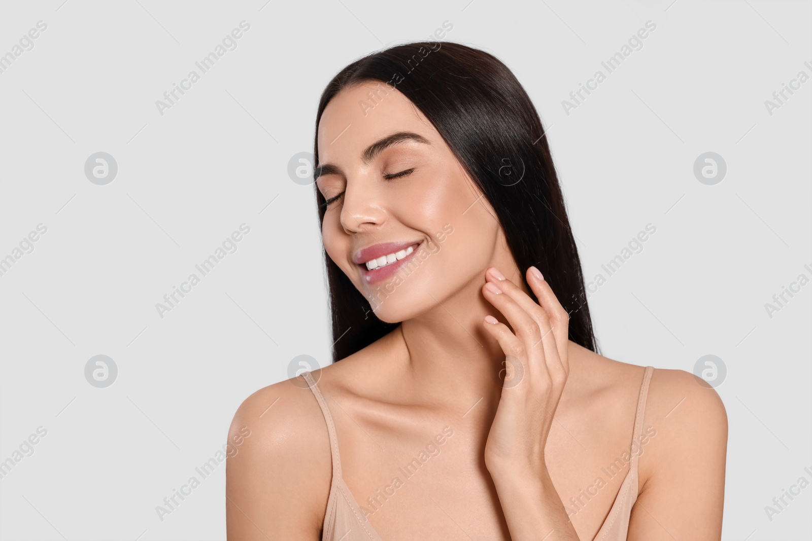 Photo of Portrait of attractive young woman on light grey background. Spa treatment