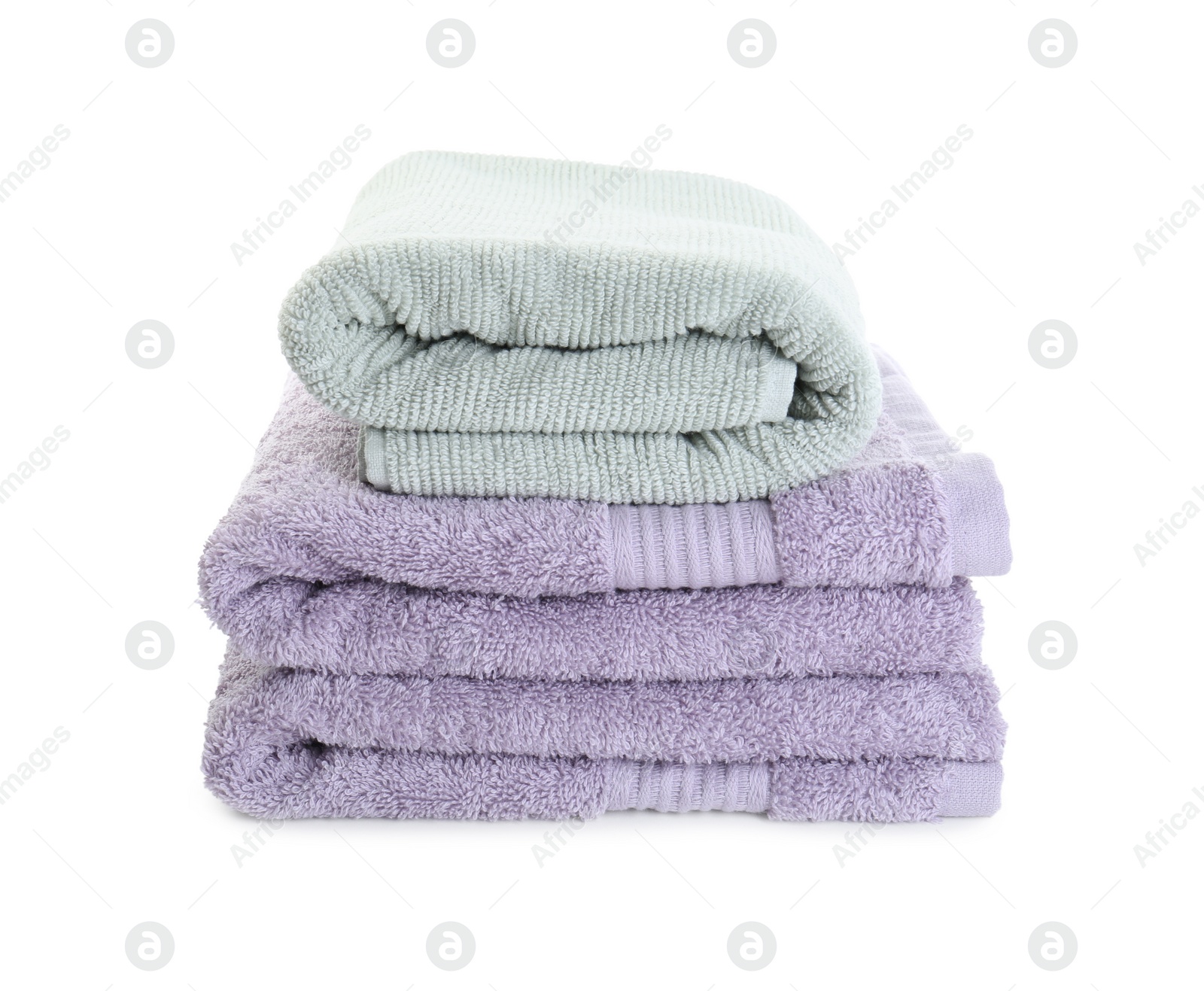 Photo of Stack of different folded terry towels isolated on white