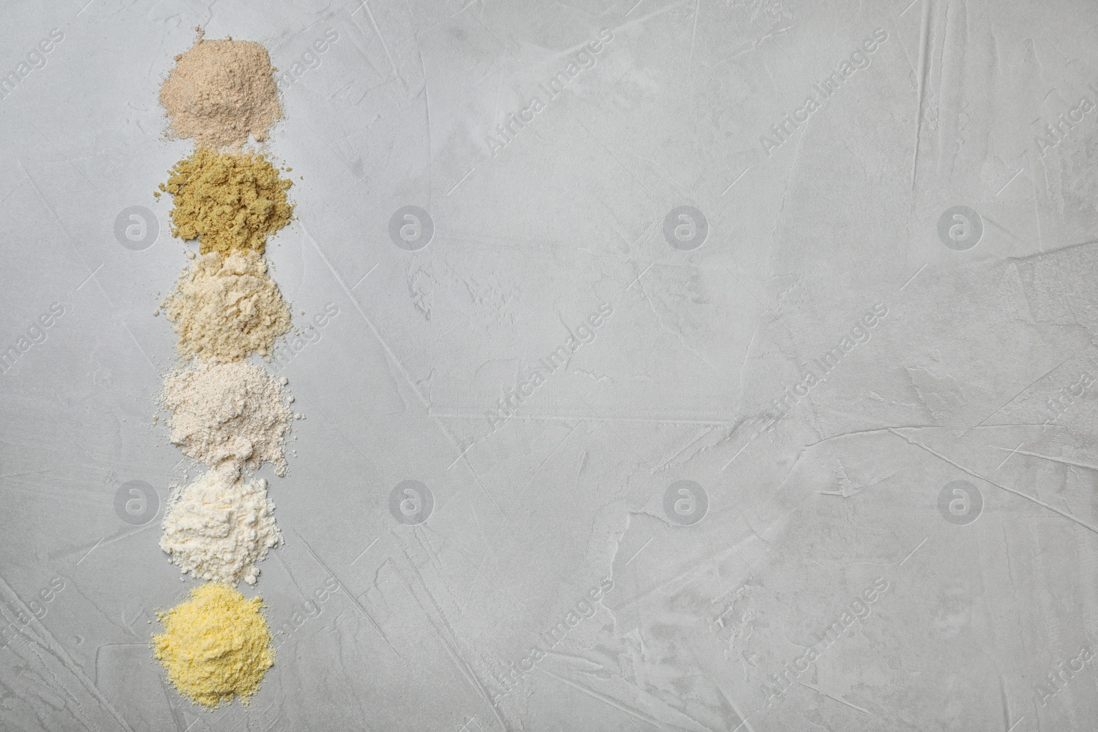 Photo of Composition with different types of flour on light background