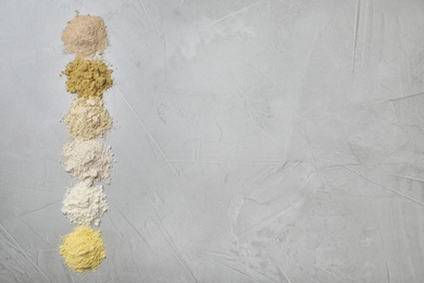 Photo of Composition with different types of flour on light background