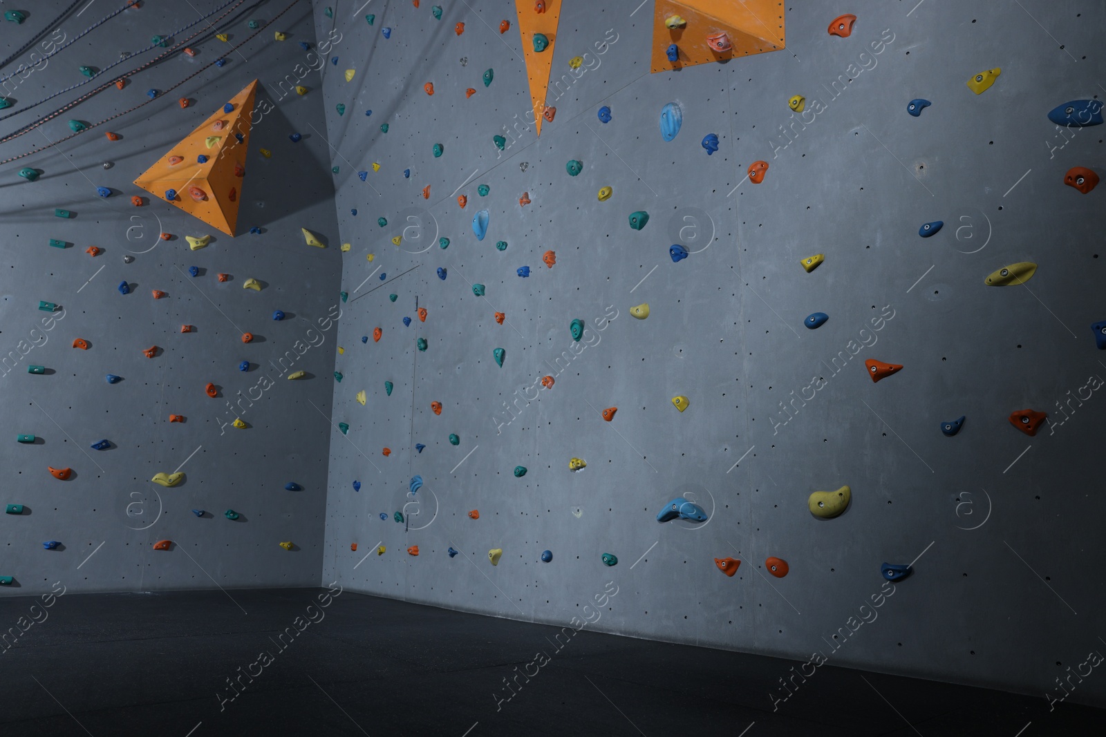 Photo of Climbing wall with holds in gym. Extreme sport