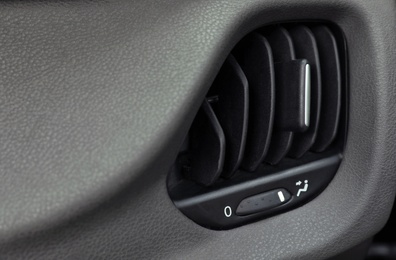 Photo of Air conditioner system in modern car, closeup