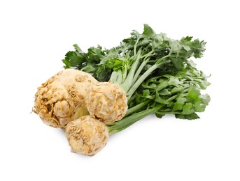 Photo of Fresh raw celery roots with stalks isolated on white
